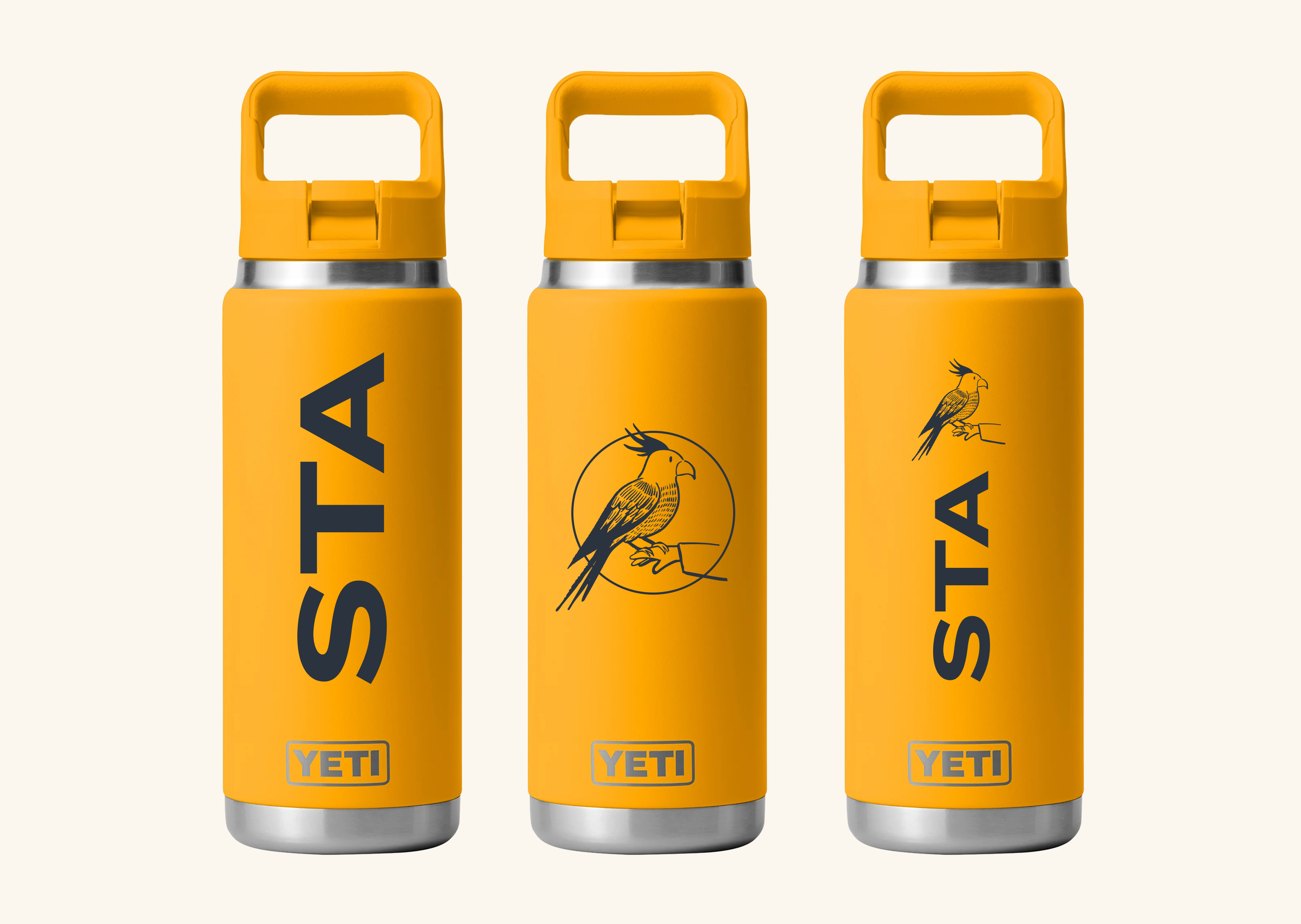 Three Signal-orange Yeti water bottles with STA wordmark, bird-circle, and bird-on-arm motifs